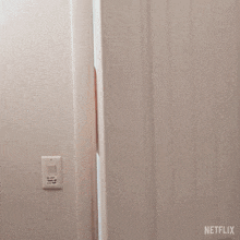 a man with a beard is standing in a doorway with a netflix logo in the corner