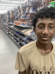 a young man is standing in a store looking at the camera and smiling .