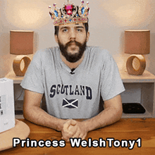 a man with a beard wearing a scotland shirt and a crown