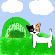 a calico cat is standing in the grass near a green bush