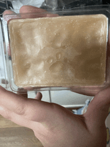 a person is holding a piece of soap that looks like ice cream