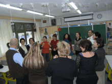 a group of people are standing in a circle in a room