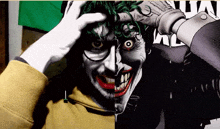 a man is holding his head in front of a joker comic book