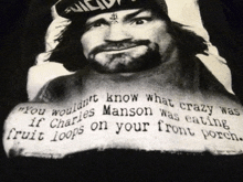 a black shirt with a picture of charles manson and a quote about him