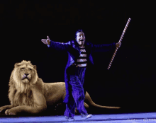 a man in a purple suit is standing next to a lion holding a cane