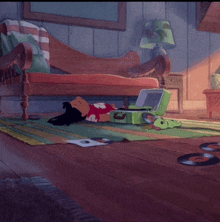 a cartoon character laying on the floor next to a green suitcase