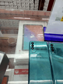 two wiko phones are on display in front of a huawei tablet