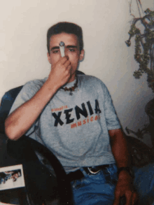 a man wearing a t-shirt that says xenia musical on it