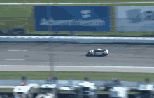 a motorcycle racer is flying through the air on a race track in front of a sign that says advent health