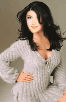 a woman wearing a sweater with a plunging neckline