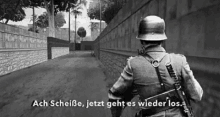 a black and white photo of a soldier with the words ach scheiße jetzt geht es wieder los below him