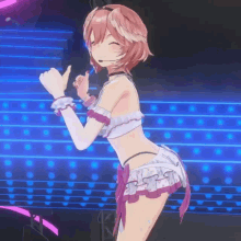 a girl in a bikini is giving a thumbs up on stage