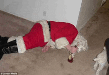 a man dressed as santa claus is laying on the floor