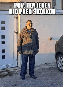 a man is standing in front of a garage door with the caption pov : ten jeden ujo pred skolkou