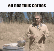 a man is holding a watermelon in front of a barrel with the words eu nos teus cornos on the bottom