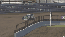 a race car with the number 7 on the side is driving down a track