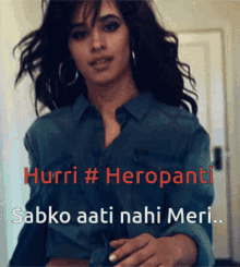 a woman in a blue shirt with the words hurri # heropani written on it