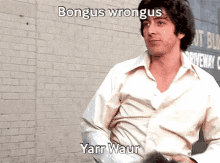 a man in a white shirt is standing in front of a brick wall with the words bongus wrongus yanr waur written above him