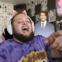 a man with a beard wearing headphones and a purple shirt with the word texas on it