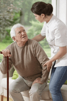 an elderly man with a cane is being helped by a woman