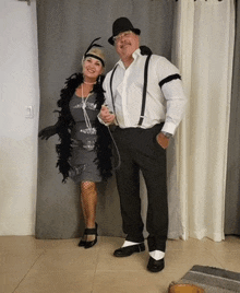 a man and a woman dressed in costumes pose for a picture