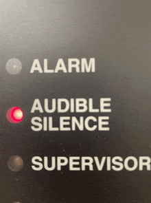 a button that says alarm audible silence and supervisor on it