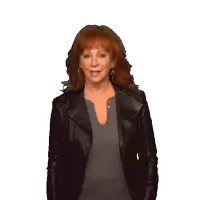 a woman with red hair wearing a black jacket