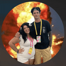 a man and a woman are posing for a picture and the woman is wearing a lanyard that says ' festival pass '