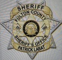 a sheriff 's badge from fulton county patrick labat