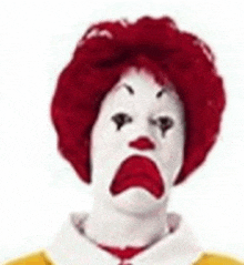 a mcdonald 's clown with red hair and white face