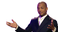 a man in a suit and tie is talking with his hands outstretched