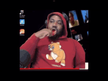 a man in a red hoodie with a teddy bear on it is eating something