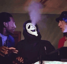 a man wearing a ghost face mask is smoking a cigarette