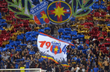 a crowd of people in a stadium with a flag that says steaua on it