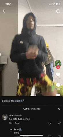 a man in a hoodie and shorts is dancing on a phone screen