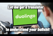 a man is using a laptop with the word duolingo on it