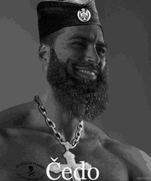 a man with a beard is wearing a chain around his neck and has the word cedo on his chest