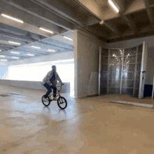 a person riding a bike in a large room