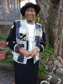 a woman wearing a hat and a quilted jacket