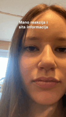 a close up of a woman 's face with a caption that says mano reakcija i sita informaciona