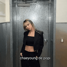 a woman standing in front of a door with the name chaeyoung de popi below her