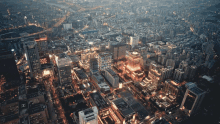 an aerial view of a city at night with a few buildings that have the letter h on them