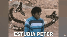 a man in a blue and white striped shirt is holding a snake with the words estudia peter written on the bottom