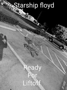 a black and white photo of a shopping cart in a parking lot