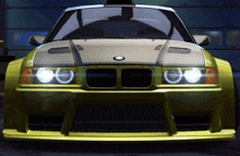 a yellow bmw with a hood that has a bmw logo on it