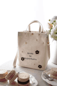 a white bag that says mom is superhero