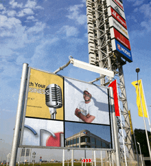 a billboard with a microphone and the words " tech your businesses " on it