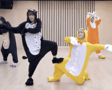 a group of people wearing animal costumes are dancing together