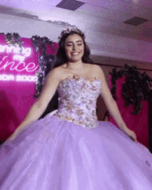 a woman in a purple ball gown is smiling in front of a sign that says ' coming of a princess '