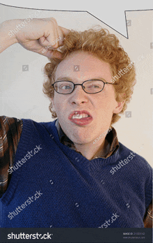 a man with red hair and glasses is making a face